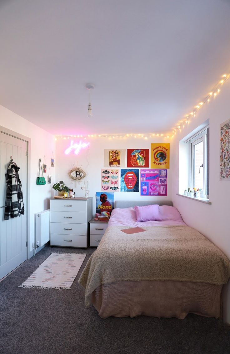 a bed room with a neatly made bed and lots of lights