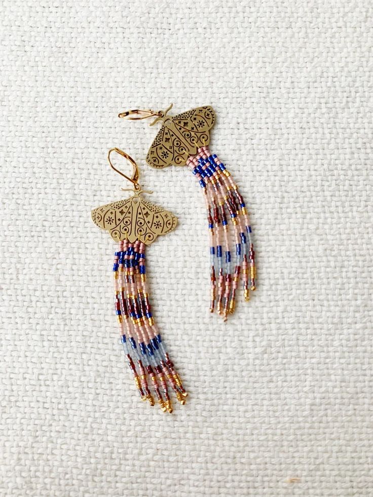 Brass Celestial Filigree Moths With Fancy Hand Beaded Fringe - Etsy Gold Jewelry With Beaded Fringe For Summer, Summer Gold Jewelry With Beaded Fringe, Summer Gold Beaded Fringe Jewelry, Bohemian Butterfly Jewelry For Festivals, Bohemian Brass Jewelry With Fringe, Elegant Blue Beaded Fringe Earrings, Bohemian Butterfly Jewelry, Blue Beaded Dangle Earrings In Brass, Bohemian Brass Fringe Jewelry