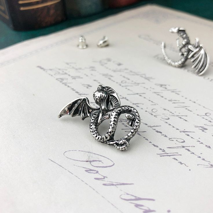 These adorable wyrmling earrings are the perfect additions to any fantasy fan's outfit! This pair of wyrmlings look as though they are nestling comfortably on your earlobes when adorned. A fantastic accessory or gift for any dragon lover. Material: Zinc Alloy Click ADD TO CART To Order Yours Now! The Checkout Process is Guaranteed to be 100% Safe and Secure with Visa, Mastercard, AMex, Discover, Apple Pay or PayPal. Fantasy Style Pierced Cartilage Earrings For Gift, Fantasy Style Silver Cartilage Earrings For Gifts, Silver Fantasy Style Cartilage Earrings As Gift, Silver Fantasy Cartilage Earrings For Gift, Dragon Lover, Apple Pay, Visa Mastercard, Zinc Alloy, Gifts