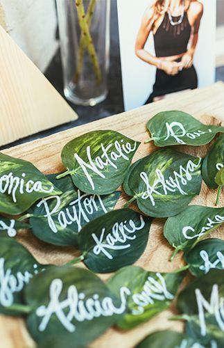 the table is covered with green leaves and white calligraphy