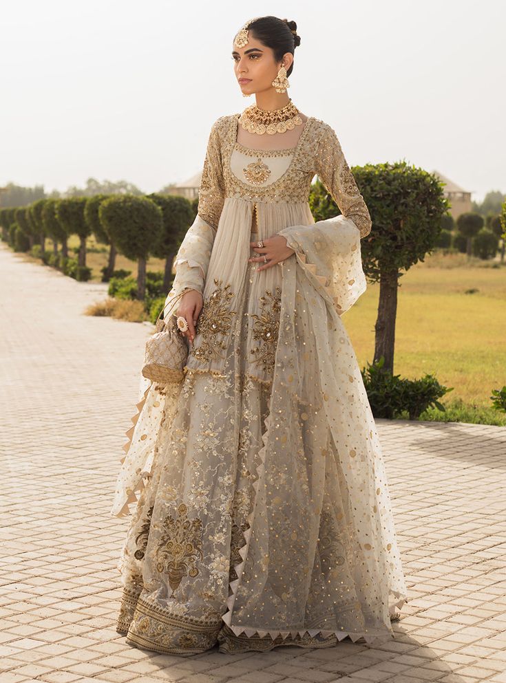 NOOREH’ is a perfect bridal ensemble for an intimate Nikkah ceremony. Look beautiful in our crushed front open short peplum accentuated with embellished floral motifs and intricately embellished neckline and sleeves. This gorgeous Sharara is heavily embroidered with floral pattern all over decorated with floral vases a Zainab Chottani, Desi Dress, Desi Wedding Dresses, Nikkah Dress, Asian Bridal Dresses, Asian Wedding Dress, Bridal Dresses Pakistan, Pakistani Wedding Outfits, Bridal Dress Fashion