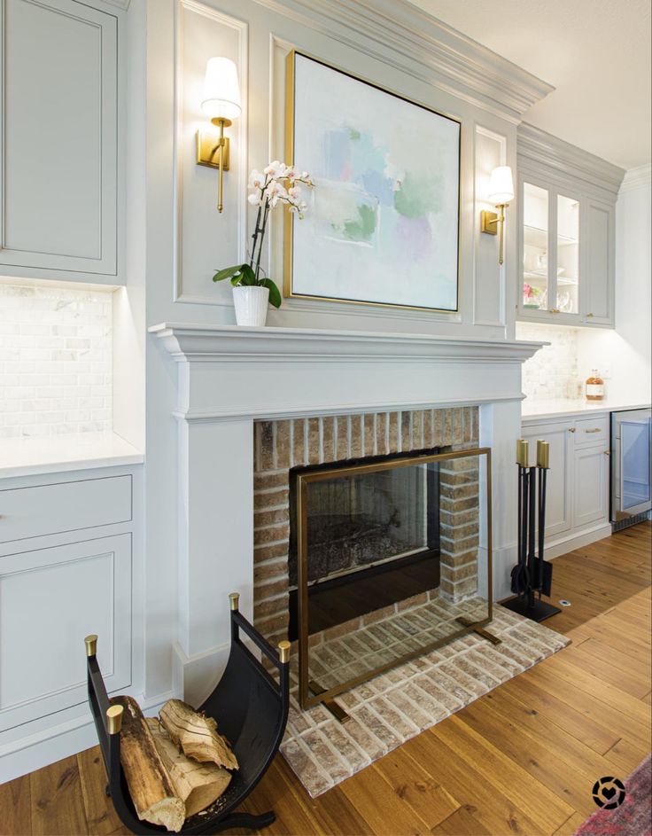 a living room filled with furniture and a fire place under a painting on the wall