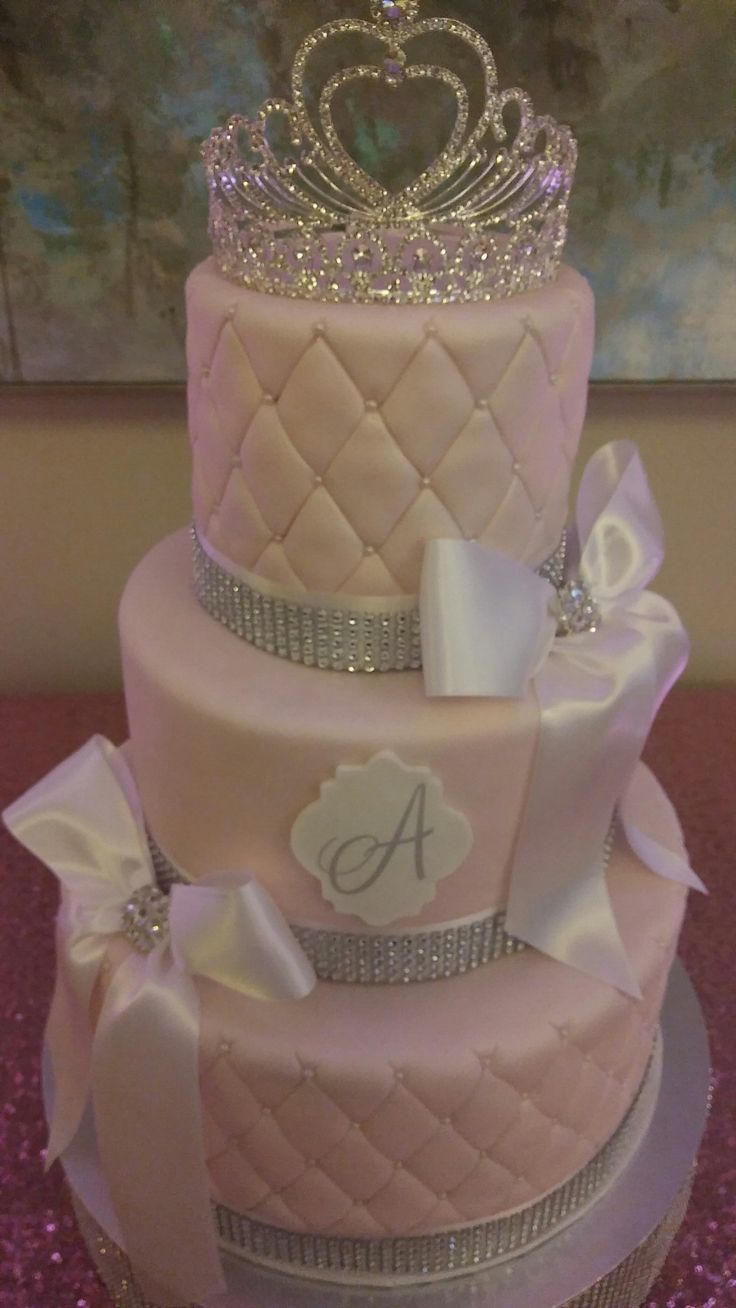 a three tiered cake with a tiara on top