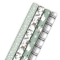 four rolls of wrapping paper on top of each other in different patterns and colors,