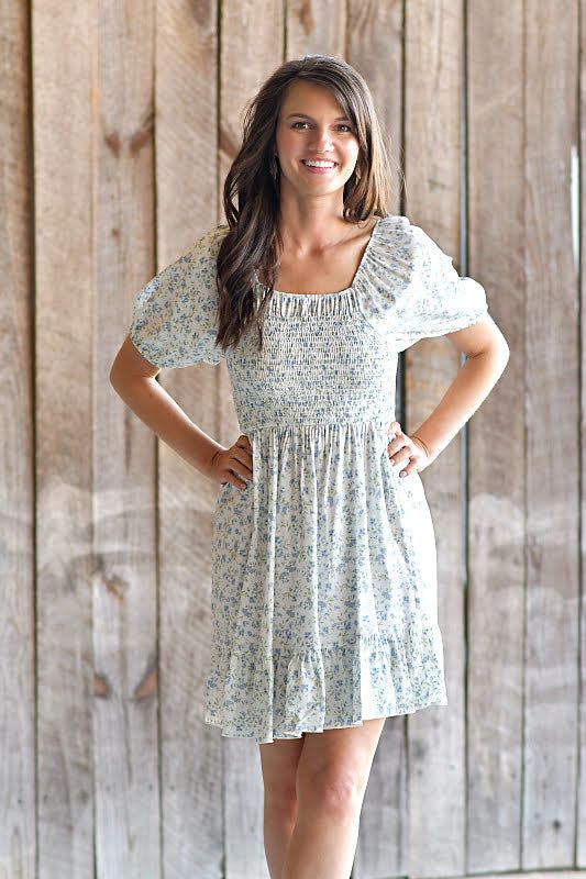 A Classic Spring vibe! You can't go wrong with this adorable floral print dress! It features a squared-smocked neckline, puffy sleeves, it is ruffled/tiered, and it is lined. ABOUT THIS ITEM: Made in USA. Fabric is 100% Rayon. Hand wash in cold water. hang or line dry. The fit is true to size. Model is 5'6, and wearing a small. Blue Floral Print Dress, Spring Vibes, Puffy Sleeves, Floral Print Dress, Spring Time, Print Dress, Cold Water, Happy Shopping, Floral Print