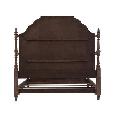 an old wooden bed frame with iron bars on the headboard and foot board, isolated against a white background