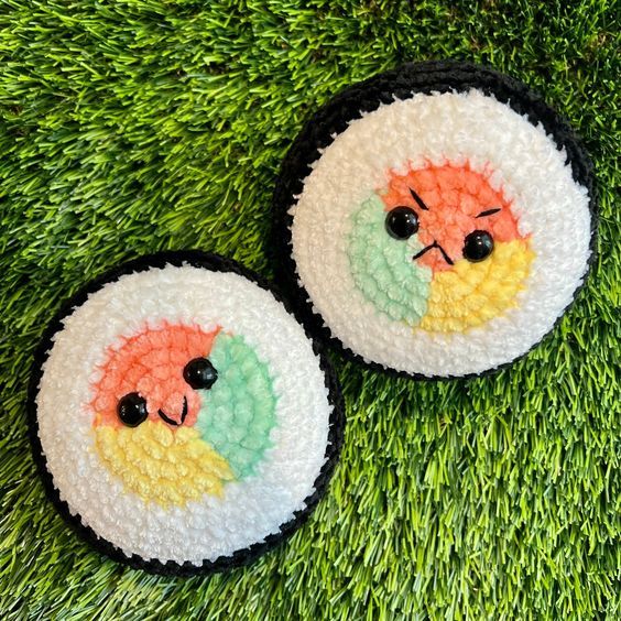 two small crocheted plates with faces on them