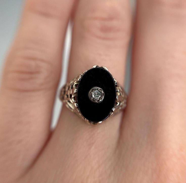 Oval onyx ring with a decorative diamond centre and beautiful detailed white gold frame shoulders and band.  Preloved item Size (approx.): 4.5 US Stamped 14K Weight: 2.137g **FREE shipping within Canada and USA** If you have any questions or concerns, please do not hesitate to contact us. We will be more than happy to help you and answer any inquiries.  We invite you to check out our shop for more fabulous items! Elegant Oval Black Enamel Ring, Formal Oval Enamel Ring With Black Enamel, Formal Oval Black Enamel Ring, Formal Black Enamel Oval Ring, Oval Black Enamel Diamond Jewelry, Oval Diamond Jewelry With Black Enamel, Oval Enamel Diamond Ring For Anniversary, Oval Diamond Enamel Ring For Anniversary, Oval Diamond Enamel Anniversary Ring