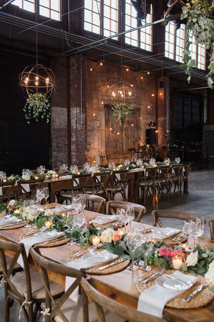 the tables are set up with place settings and flowers on them for an elegant dinner