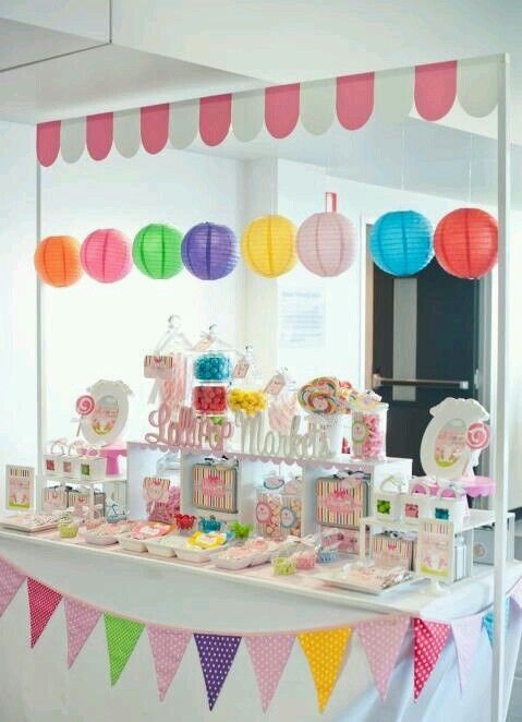 a table topped with lots of candy and candies on top of a white table