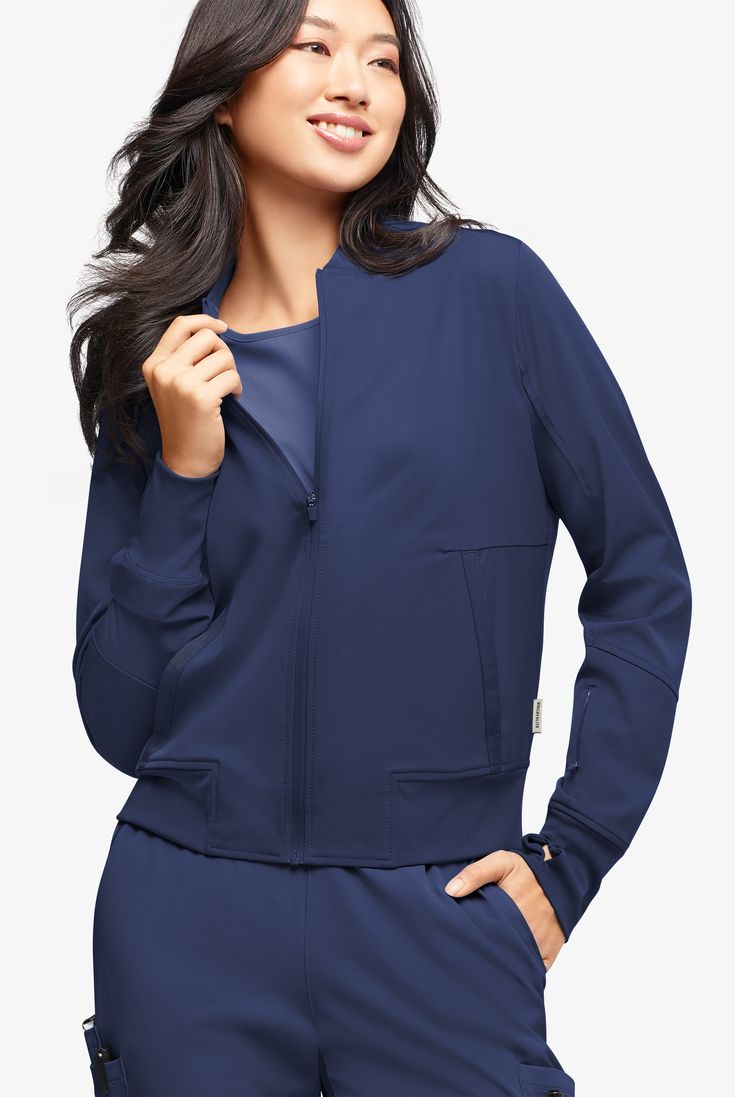 A jacket that’s cool from fabric to style. It’s a classic bomber with so many amazing details: rib-knit cuffs with thumbholes, feminine grosgrain ribbon trim and 4 pockets. It’s even lined through the body for a smooth finish. WhisperLite may be your coolest-feeling scrubs ever. Feather light poplin with wicking and 4-way stretch that also repels lint, fur, and hair. And with extra chic, feminine styling, they look cool too. • Modern fit • Bomber style • Rib-knit collar • Full-length front zippe Stretch Outerwear With Ribbed Collar And Long Sleeves, Stretch Solid Outerwear With Ribbed Cuffs, Stretch Long Sleeve Outerwear With Ribbed Cuffs, Stretch Outerwear With Ribbed Cuffs And Long Sleeves, Fall Track Jacket With Pockets For Layering, Casual Track Jacket With Pockets For Layering, Fall Long Sleeve Track Jacket With Elastic Cuffs, Workwear Track Jacket With Ribbed Collar And Long Sleeves, Blue Stretch Outerwear With Zipper Closure