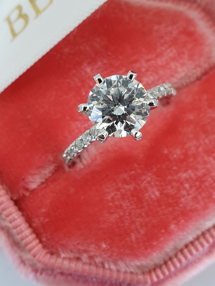 an engagement ring in a red velvet box