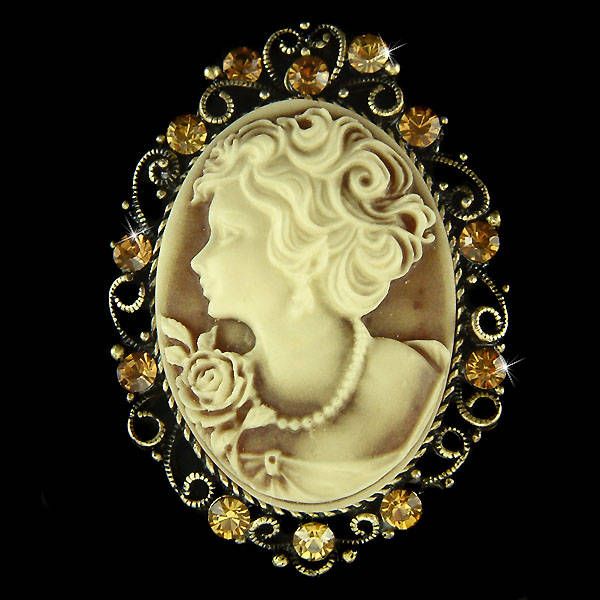 "PERFECT CHRISTMAS / VALENTINE / MOTHER'S DAY GIFT !! PERFECT GIFT /WEDDING GIFT FOR BRIDE / BRIDESMAID / LADY! This Classy, Antique gold look TOPAZ BROWN Cameo pendant / Pin with Swarovski crystals measures 1 1/2\" wide X 2 1/8\" high (38mm X 53mm) with antique gold finish. And it can be a beautiful pendant also because there is a hole at the back. Crystal Color: Light Col Topaz, Smoked Topaz It goes well with modern as well as vintage styling...it really depends how you want to wear it. Great White Cameo Brooch For Wedding, White Cameo Brooches For Wedding, White Cameo Wedding Brooches, Wedding Jewelry With Rhinestones For Christmas, Christmas Wedding Jewelry With Rhinestones, Christmas Wedding Rhinestone Jewelry, Gold Cameo Brooch For Wedding, Wedding Gift For Bride, Vintage Styling