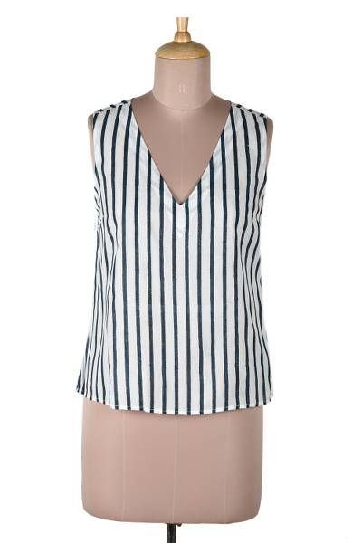 Keep cool on hot summer days with this impossibly chic sleeveless blouse designed by Indian artisan Ritu Agnihotri. Hand crafted from soft breathable viscose the top features a vertical stripe pattern that's hand block-printed in navy and white. A v-shaped neckline adds an elegant yet saucy touch. Chic Sleeveless Summer Vest, Sleeveless Cotton Vest For Summer, Chic Summer Tank Vest, Elegant Sleeveless Tank Top For Summer, Elegant V-neck Summer Tops, Cotton V-neck Summer Top, V-neck Cotton Top For Summer, Sleeveless Linen Summer Vest, Fitted Sleeveless Summer Tank Top