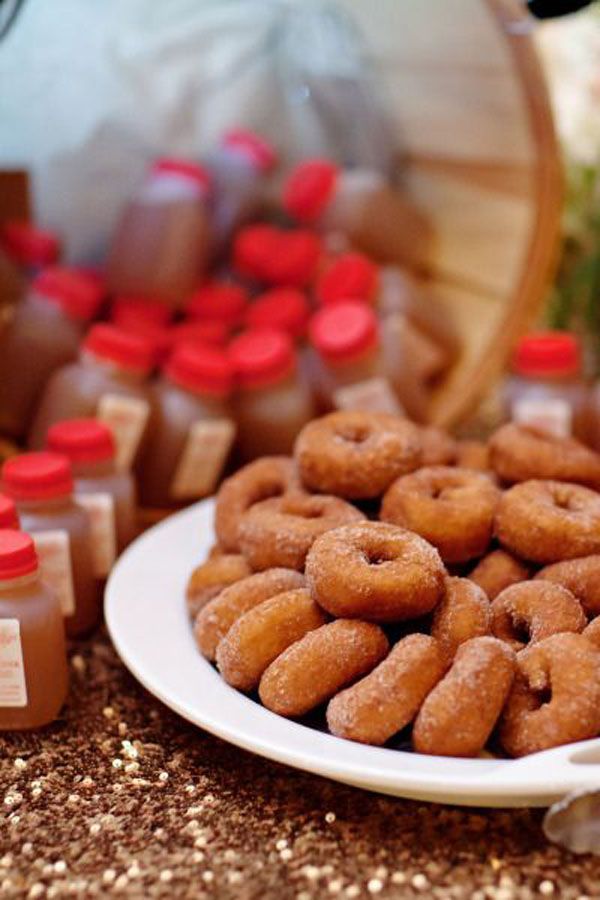 there are many donuts on the plate next to some honey bottles and other items