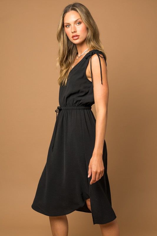 Elevate your summer wardrobe with the Raelyn Sleeveless V-neck Mini Dress, a perfect blend of flirty style and feminine details. This dress showcases a flattering V-neckline and delicate shoulder ruching, creating a chic and figure-enhancing silhouette. Whether paired with sandals for a daytime look or heels for an evening out, the Sleeveless V-neck Shoulder Ruching Mini Dress offers a versatile and stylish choice that's perfect for warm-weather occasions.Model is 5’10” wearing a size small Fabric Contents: 100% Polyester, Non-stretch fabric, Non-sheer fabricSize Measurement (inch): S: 17.5 (Bust), null (Waist), null (Hips), 43.0 (Length) M: 18.0 (Bust), null (Waist), null (Hips), 43.5 (Length) L: 18.5 (Bust), null (Waist), null (Hips), 44.0 (Length) Chic Sleeveless V-neck Dress With Tie Back, V-neck Sundress With Knotted Straps For Day Out, Summer V-neck Dress With Knotted Straps, Solid V-neck Midi Dress With Smocked Back, Elegant V-neck Sundress For Brunch, Flattering V-neck Summer Dresses, Spring V-neck Ruched Sundress, Flirty V-neck Sleeveless Dress For Spring, Chic V-neck Maxi Dress With Knotted Straps