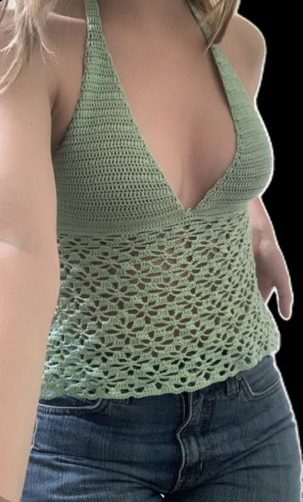 a woman wearing a green crochet top with her hand on her hip and looking at the camera