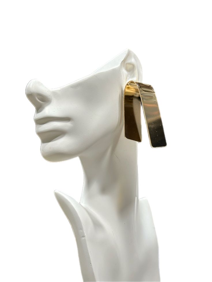 The Modernist Chic Fold Earrings are a stylish and contemporary accessory that effortlessly blends minimalist aesthetics with a touch of sophistication. With a length of 2.5 inches and a width of 1.2 inches, these earrings offer a bold yet elegant presence. Available in two stunning variants, gold and silver, they cater to diverse tastes, adding versatility to any wardrobe. The cleverly designed fold accentuates their modern appeal, making them a must-have accessory for those seeking a timeless and chic statement piece. Chic Metal Dangle Clip-on Earrings, Chic Metal Drop Clip-on Earrings, Modern Gold Earrings For Party, Chic Linear Earrings For Formal Occasions, Elegant Metal Plug Earrings, Modern Drop Earrings, Minimalist Metal Clip-on Earrings For Formal Occasions, Chic Pierced Linear Earrings For Formal Occasions, Modern Rectangular Jewelry For Party