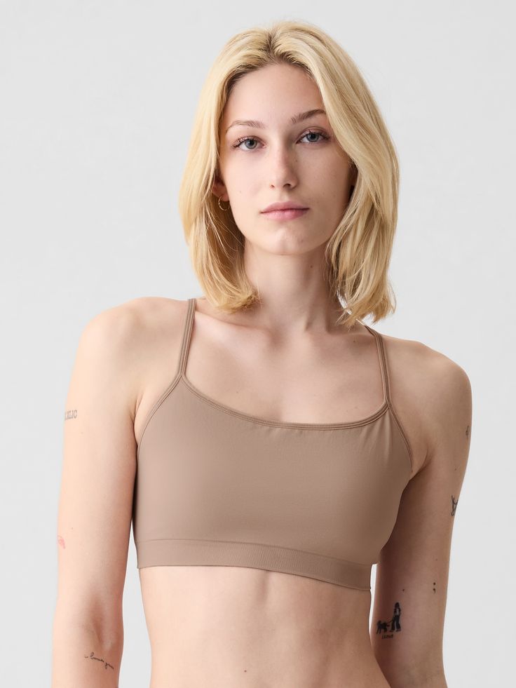 Supersoft, seamless, stretch nylon-blend bralette.  Scoop neck, racerback.  Elasticized trim at scoopneck, spaghetti straps.  This product was made in a factory that invests in gender equality and women’s empowerment.  Through RISE Reimagining Industry to Support Equality) and Gap Inc. ’s program P. A. C. E.  Personal Advancement & Career Enhancement), we support people who make our clothes to build the skills, knowledge, confidence, and resilience needed to advance in work and life.  Learn more Scoop Neck Bra With Built-in Support, High Stretch Scoop Neck Sports Bra With Built-in Bra, Seamless Stretch T-back Sports Bra, Scoop Neck Seamless Bra, Stretch Crop Top With Built-in Bra And T-back, Strappy Back Stretch Camisole With Built-in Bra, Seamless Sports Bra With Scoop Neck And Minimal Stretch, Stretch Crop Top With Built-in Bra And Strappy Back, Stretch Crop Top With Strappy Back And Bra Friendly