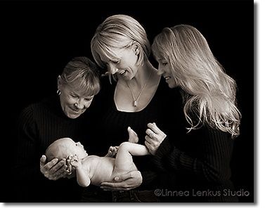 a woman and two boys are holding a baby