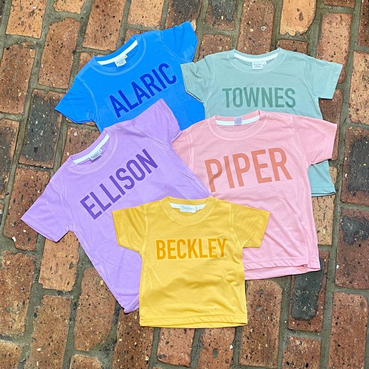 Monochrome name shirts! Personalize with name, or nicknames like babe, sister, or brother! These are great for family pictures, name announcements, gender reveals, and everyday wear! Choose from blue, pink, sage, lavender, or mustard 100% poly shirts. These tees have a cotton feel and are SO soft!  My shirts are all handmade using the sublimation process. The image is printed on an 100% polyester tee through a professional printing process. The ink infuses with the fibers, making the design part Family Matching Cotton Shirt For Playtime, Family Matching Short Sleeve Tops, Family Matching Solid Color Short Sleeve Tops, Personalized Family Matching T-shirt For Summer, Family Matching Tops For Gender Reveal In Summer, Summer Family Matching Tops For Gender Reveal, Family Matching Tops For Summer Gender Reveal, Customizable Playful Cotton Tops, Short Sleeve T-shirt For Gender Reveal In Summer