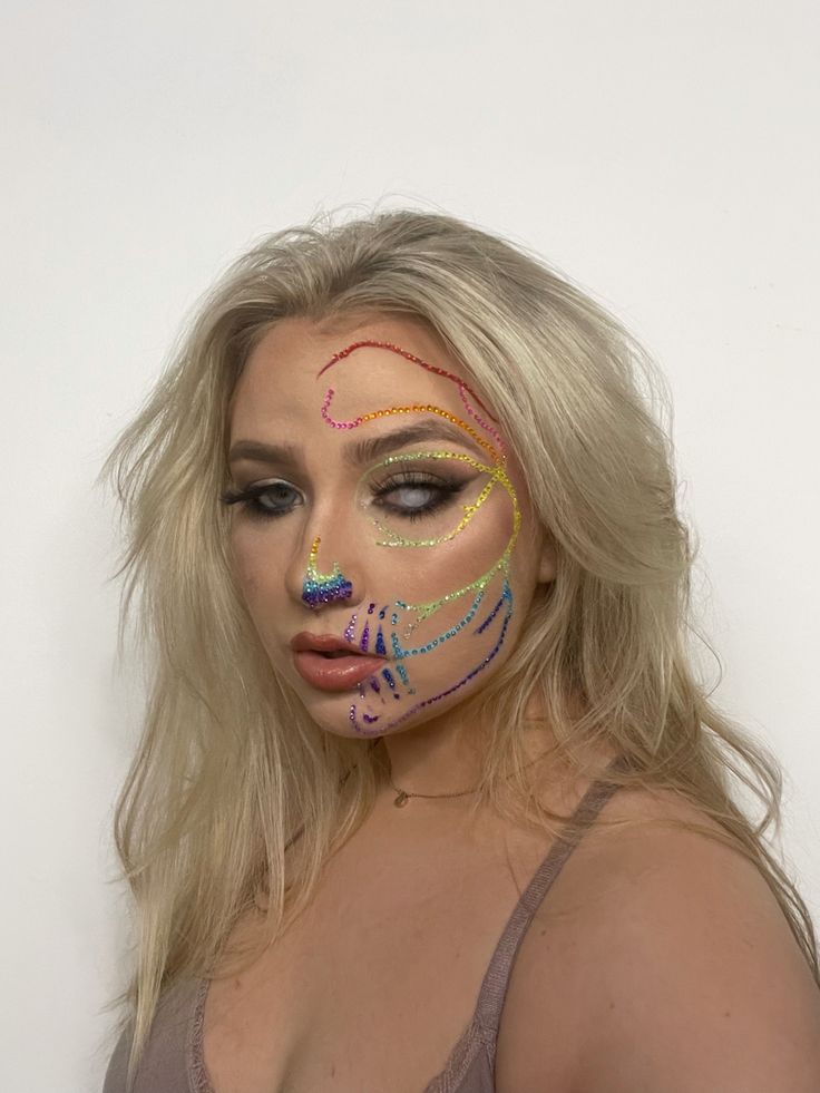 This is a rainbow rhinestone skull makeup look on half of my face. Halloween Makeup Inspo, Rainbow Skeleton, Skull Halloween Makeup, Rainbow Skull, Rhinestone Skull, Skeleton Makeup, Skeleton Costume, Diy Rainbow, Skull Makeup