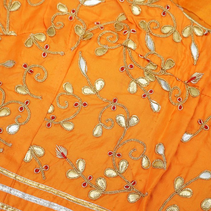 Category: Banarasi Fabric Khinkhwab brings you beautiful fabrics with intricate gotta patti embroidery. All the measurements are shown in the picture. This is 38 chest blouse. Non-padded. Fabric: Pure Silk Note- There may be slight color variations due to photographic reasons. This is a hand-woven product and any irregularities in the weaving or pattern should not be taken as a defect. These irregularities make every handloom piece unique. Festive Orange Embroidered Lehenga, Orange Embroidered Chanderi Lehenga, Bollywood Style Embroidered Orange Lehenga, Orange Embroidered Dola Silk Lehenga, Orange Raw Silk Choli With Resham Embroidery, Embroidered Orange Choli For Navratri, Bollywood Style Raw Silk Traditional Wear With Gota Work, Bollywood Style Orange Embroidered Choli, Orange Raw Silk Choli With Zari Work