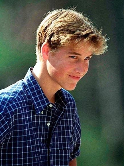 black and white photograph of a young man with short hair wearing a plaid shirt looking at the camera