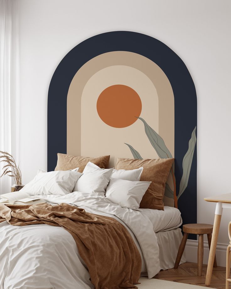 a bed with white sheets and pillows in front of a large painting on the wall