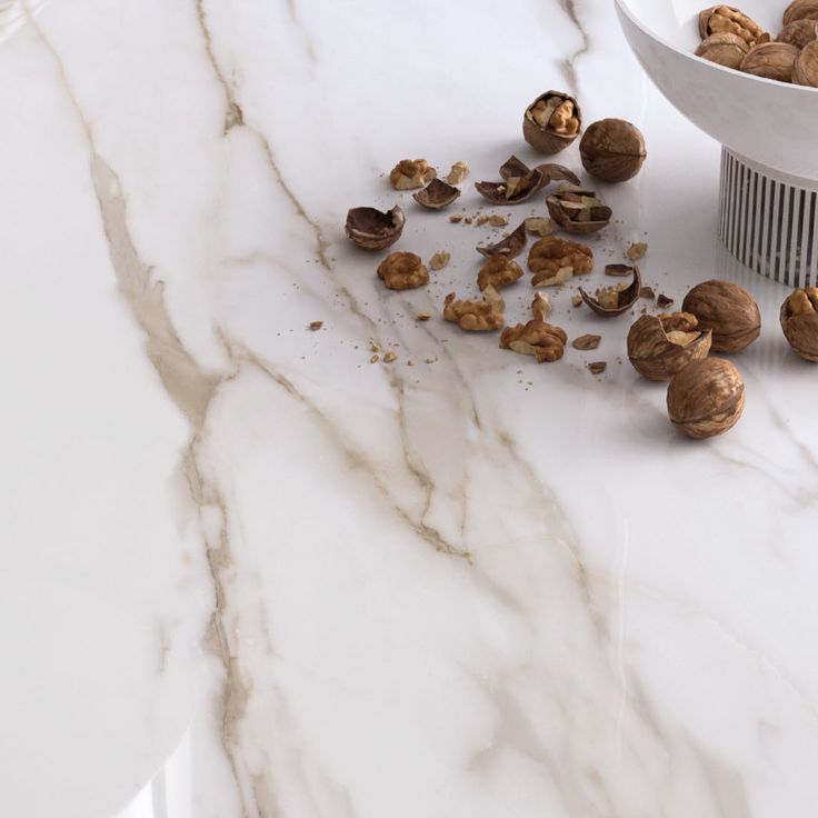 some nuts are on the counter top next to a bowl