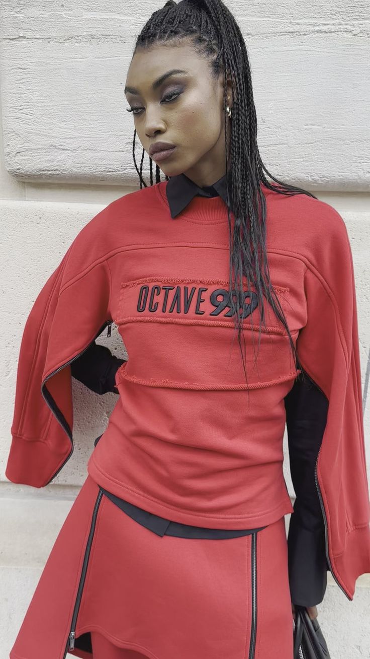 a mannequin wearing a red outfit with black writing on it's chest