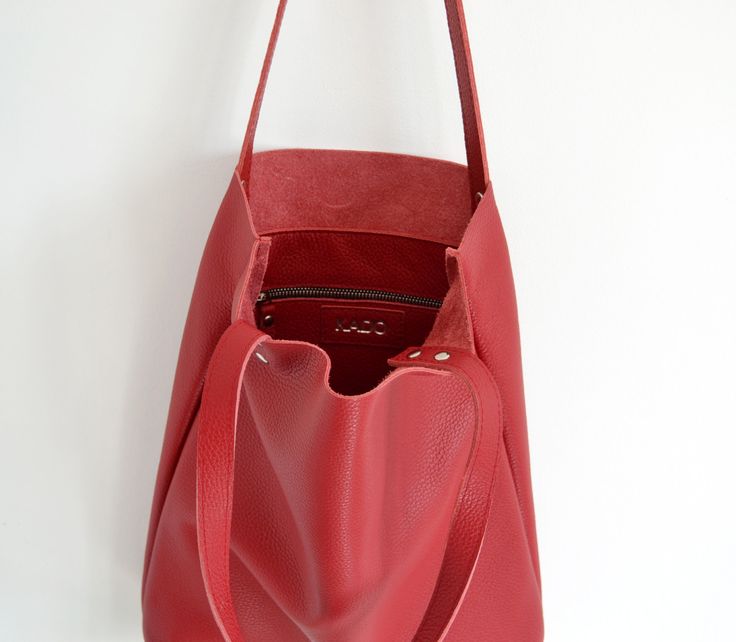 "SIMPLE LEATHER TOTE BAG Please click + More at the end of the description to see more details. Dimensions: Height: 15.5'' 39 cm Width: 12.2'' 31 cm Handles: 23.6'' 60 cm Handle drop: 10.2\" 26 cm Casual and simple tote bag made from high quality pebbled leather. It is slim, lightweight, strong and fits comfortably over the shoulder. * Highest quality Italian leather * Includes interior zipped pocket and key chain * Zipper & Hardware (Luxury gold or silver) * Fits a laptop (up to 13 inch) * Red Hobo Tote Bag For Daily Use, Red Hobo Bag Tote For Daily Use, Red Hobo Tote Bag With Large Capacity, Red Hobo Bag Large Capacity Tote, Red Hobo Bag With Large Capacity, Red Shoulder Bag With Removable Pouch For Everyday, Modern Red Satchel For Errands, Red Everyday Shoulder Bucket Bag, Modern Red Satchel