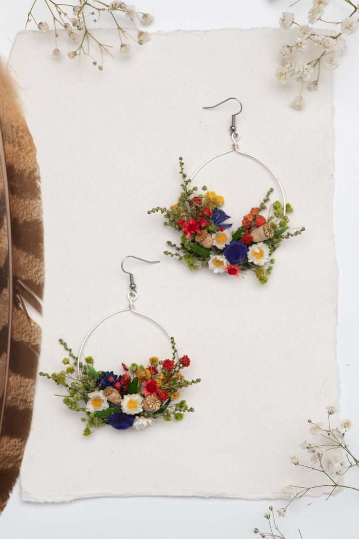 Flower circle dangle earrings in folk style. Can be used for weddings, other events or just everyday use. The earrings are made of preserved flowers, leaves and grass, wire, and other trinkets used for arranging :) Size: width 6cm (2.5 inches), 8cm long. They weight only 8-10g or 3 cm (1.2 inches) - weight 5-8g Please choose the material: 1. GOLD IMITATION HOOK (golden imitation wire/circle + golden imitation hook) 2. SURGICAL STEEL HOOK (silver imitation wire + surgical steel hook) 3. SILVER HO Handmade Delicate Flower Hoop Earrings, Bohemian Beaded Flower Earrings, Silver Earrings With Pressed Flowers For Wedding, Silver Wedding Earrings With Pressed Flowers, Wedding Pressed Flower Drop Earrings, Wedding Drop Earrings With Pressed Flowers, Wedding Silver Earrings With Pressed Flowers, Bohemian Dangle Earrings With Pressed Flowers, Bohemian Drop Earrings With Pressed Flowers