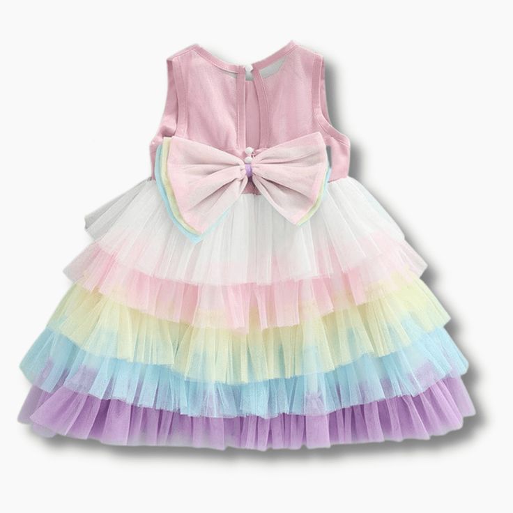 This charming, rainbow layered dress will make your little princess look just as glamorous as you! It features a multicolor, layered skirt, a tulle bodice and a bow at the back. Made for special occasions, this versatile dress can also be worn casually. Influencer @helena.modenezi Material: Cotton, polyester Playful Multicolor Tiered Dress, Sleeveless Tulle Tutu Dress With Bow, Spring Princess Tutu Dress With Bow, Spring Princess Style Tutu Dress With Bow, Spring Tulle Dress With Bow, Spring Tulle Dress With Bow Detail, Cute Spring Tutu Dress With Bow, Spring Tulle Tutu Dress With Bow, Summer Tutu Dress With Bow For Dress-up