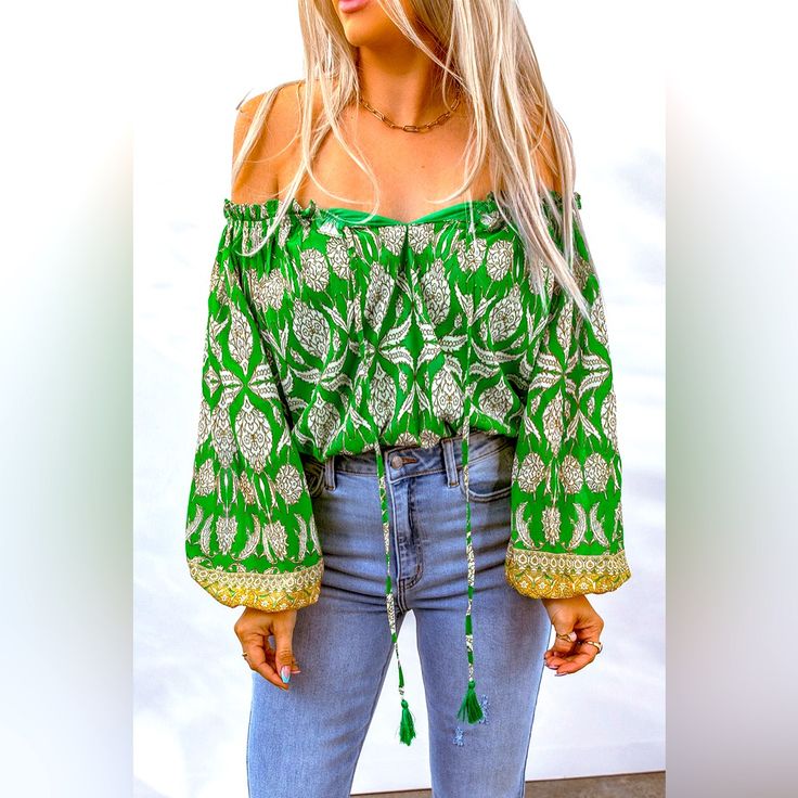 Bohemian Printed Tassel Tie Blouse! Designed With A Free-Spirited, Fun Touch, This Blouse Is Sure To Make An Impression Anywhere. It Features An Absolutely Dazzling Off-Shoulder Neckline, With A Drawstring Closure For That Perfect Fit. Long Balloon Sleeves Create An Elegant Silhouette, And The Floral Pattern Is Oh-So Chic. Add A Touch Of Boho Flair To Your Everyday Wardrobe With This Beautiful Boho Blouse You Won't Regret It! Pet Free/Smoke Free Home. Bohemian Fall Top With Tassels, Bohemian Top With Tassels For Fall, Bohemian Tops With Tassels For Fall, Green Bohemian Tops For Fall, Bohemian Long Sleeve Blouse With Fringe, Bohemian Long Sleeve Fringe Blouse, Bohemian Cotton Blouse With Back Tassel Tie-up, Summer Festival Blouse With Tassel Ties, Bohemian Long Sleeve Festival Tops