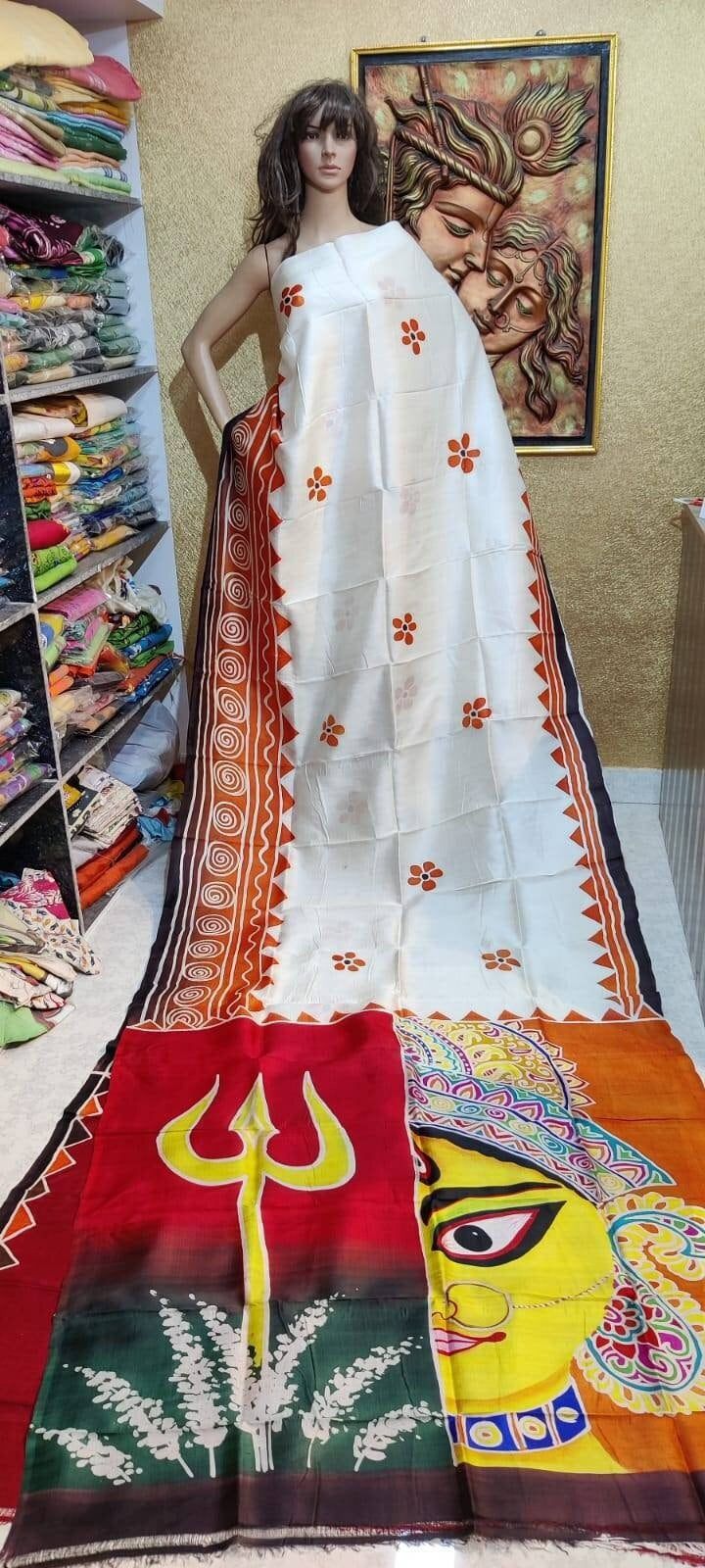 This design based on the Traditional Maa durga drawing art work mix colour work over the saree with two half color body work. With maa durga drawing work with sewliful(sewli flower) Feel the Original Murshidabadi/Bishnupu Silk, It comes with hand paint design by the artist, Every painting 🎨🖌dedicated to the nature story of Indian art, forest, trees, animals, and also the flavor of every culture expect of our Indian tradition, Not only the design the yarn cultivation to the processes of it's al White Navratri Dupatta With Motifs, Tussar Silk Anarkali Dupatta For Rituals, Traditional Wear With Zari Work In Artistic Drape, Multicolor Saree With Zari Work For Rituals, White Art Silk Dupatta With Motifs, Tussar Silk Anarkali Saree For Rituals, White Silk Saree For Puja, Artistic Saree With Traditional Patterns For Puja, Multicolor Block Print Salwar Kameez For Navratri