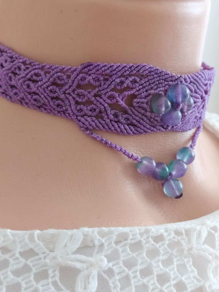 Our necklace is carefully and patiently handcrafted using the macrame technique with natural fluorite beads and high-quality, durable polyester waxed cord Our necklace is in a choker style. The total length of the necklace is 90 cm, with 25 cm of woven part. The longest part of the necklace, including the bead pendant, is 5.5 cm. Thanks to its adjustable sliding clasp, you can easily adjust it to your size and comfortably put it on or take it off. To clean the necklace, gently wash it with warm water. This necklace is our own unique design, making it one of a kind and an ideal gift. It can be a wonderful present for special occasions such as birthdays, Christmas, or anniversaries, whether for your spouse, a friend, or even for yourself. Please don't hesitate to ask if you have any question Hippie Macrame Choker Necklace, Adjustable Macrame Choker, Handmade Bohemian Waxed Cord Choker, Hippie Choker With Adjustable Cord For Gift, Hippie Choker With Adjustable Cord As Gift, Hippie Style Choker With Adjustable Cord As Gift, Bohemian Waxed Cord Choker Necklaces, Bohemian Waxed Cord Choker Necklace, Adjustable Purple Choker