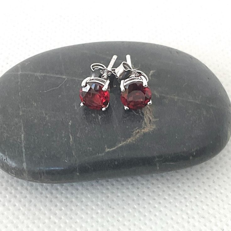 These womens red stone stud earrings are vintage, sterling silver jewellery. A lovely bright colour, the red earrings are prong set in a high base. Pretty red studs.         The womens earrings are in excellent condition, with brand new butterfly backs. They have been thoroughly cleaned as well. The stud earrings are just under 1/4 inch (5mm) in diameter.  FREE shipping in the UK. Choose a bracelet too: https://www.etsy.com/uk/shop/ReTainReUse?section_id=14455987 You can see other gift ideas her Red Round Earrings For Anniversary, Red Pierced Earrings For Anniversary, Garnet Gemstone Earrings, Red Classic Jewelry With Matching Earrings, Classic Red Jewelry With Matching Earrings, Formal Red Earrings With Prong Setting, Red Round Anniversary Earrings, Luxury Red Round Anniversary Earrings, Red Fine Jewelry Earrings For Anniversary