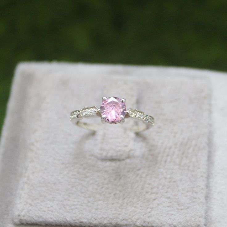 * Material: 925 Sterling Silver * DETAILS ✥ Handmade Ring ✥ - Center Stone: Lab Pink Sapphire  - Center Stone Size: 6 MM - Center Stone Shape: Round  - Side Stone: CZ diamond  ✥ O T H E R ∙ I N F O R M A T I ON ✥ ♦ Your item will be nicely packed to gift in elegant jewelry boxes. ♦ Custom Order We can make custom rings in almost any shape and style. If you want a specific model, please send us a clear picture and we will do our best. ♦ Delivery All Item will be Shipped within 3 to 5 Days after p Pink Diamond Rings With Diamond Cut, Pink Sapphire Round Cut Ring For Wedding, Pink Sapphire Ring For Wedding, Pink Sapphire Wedding Ring Round Cut, Pink Round Cut Sapphire Ring For Wedding, Pink Round Cut Sapphire Wedding Ring, Pink Sterling Silver Wedding Jewelry With Accent Stones, Pink Cubic Zirconia Diamond Ring, Round Cut, Pink Sapphire Diamond Ring For Anniversary