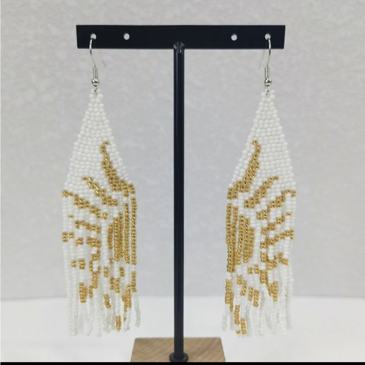 Bohemian Seed Bead Tassel White And Gold Sun Earrings Color: White And Gold That Form The Sun When Put Together New Without Tags In Excellent Condition White Beaded Fringe Festival Jewelry, Traditional White Beaded Fringe Jewelry, Festival White Beaded Fringe Jewelry, White Beaded Earrings For Summer, White Bohemian Beaded Dangle Earrings, White Bohemian Jewelry With Dangling Beads, White Fringe Tassel Earrings For Festivals, Gold Latkans Earrings For Beach, Gold Earrings With Latkans For The Beach