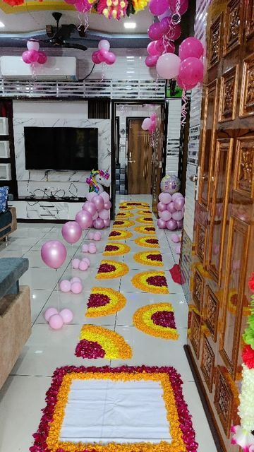 a decorated hall with balloons and flowers on the floor