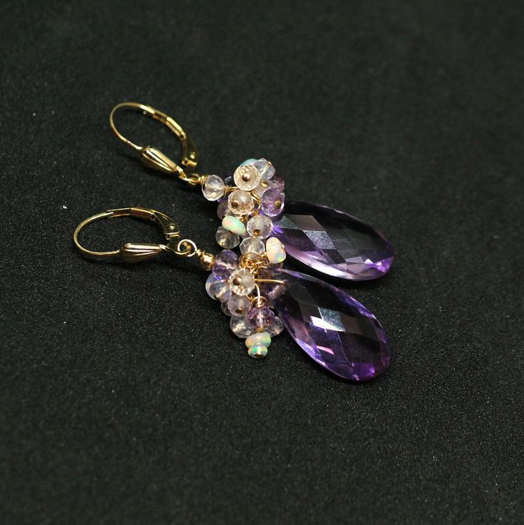 "Pink Amethyst, Rose Quartz and Ethiopian Opal Gemstone Earrings in Gold Filled. Stunning large Pink Amethyst briolettes, wrapped with high quality 14k gold filled wire, suspended from a cluster of shimmering Opal, Pink Amethyst and Rose Quartz beads. These are the best quality Pink Amethyst gems I have seen, transparent with a warm and uniform color - really unique and one of a kind! Light, dangly, shimmering feminine, chic statement earrings, perfect for special occasion, wedding, holidays or Formal Briolette Earrings With Gemstone Accents, Elegant Crystal Earrings With Gemstone Accents, Elegant Amethyst Earrings With Natural Stones, Purple Gemstone Accented Drop Earrings, Purple Drop Earrings With Gemstone Accents, Crystal Gemstone Earrings In Fine Jewelry Style, Crystal Gemstone Earrings Fine Jewelry, Amethyst Gemstone Drop Earrings With Accents, Fine Jewelry Amethyst Earrings With Gemstone Accents