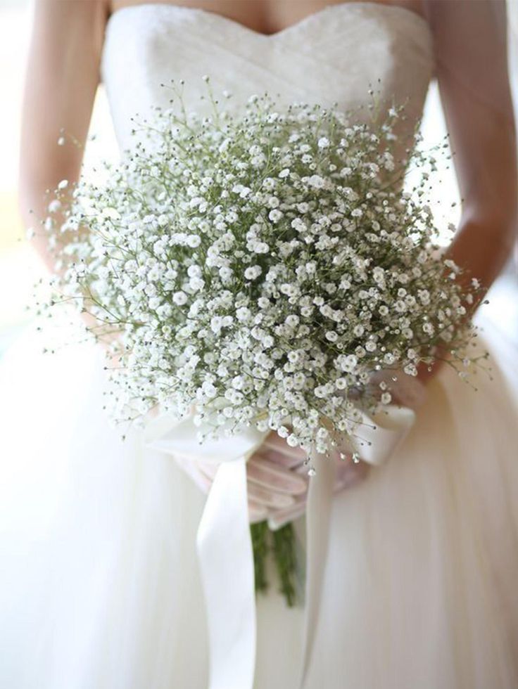 a bridal holding a bouquet of baby's breath