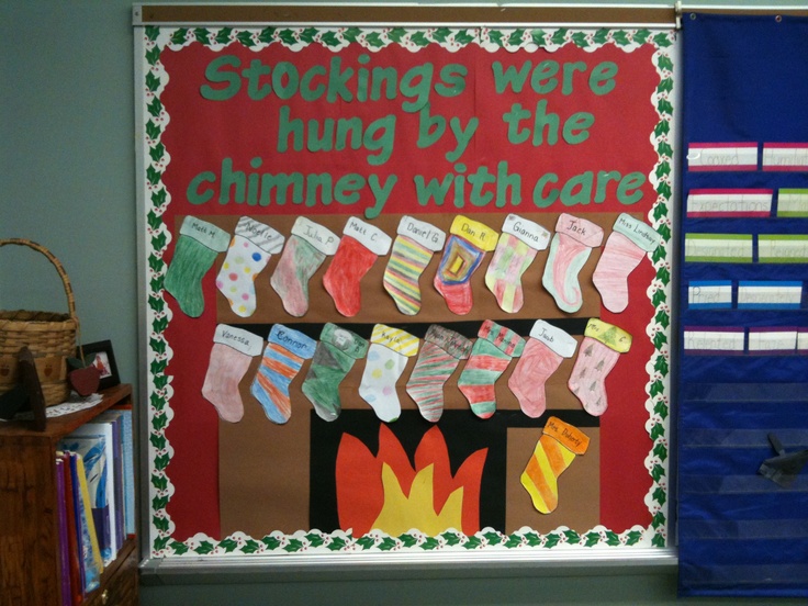 a bulletin board with stockings hung by the chimney