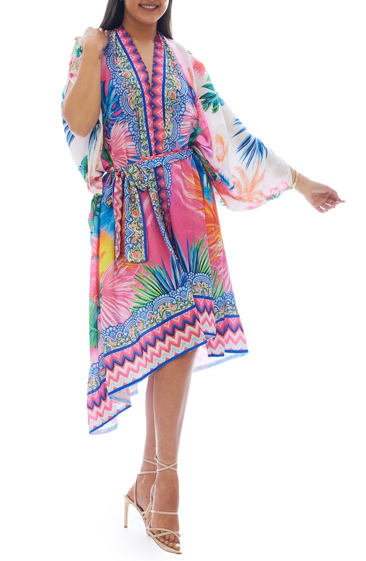 Strut your stuff down to the pool in this lightweight ruana with a bold pattern for eye-catching appeal. Ties at front V-neck
 Long sleeves 100% polyester Hand wash, dry flat Imported Model stats: 5'10" height, 32" bust, 25" waist, 36" hip. Multicolor Printed Cover-up With Kimono Sleeves, Tropical Multicolor Kimono Sleeves Cover-up, Multicolor V-neck Cover-up For Pool, Multicolor Hawaiian Cover-up With Tropical Print, Casual Pink Printed Cover-up, Multicolor Tropical Print Kaftan For Vacation, Pink Vibrant Print Kaftan For Vacation, Vacation Tropical Print Multicolor Kaftan, Vacation Multicolor Tropical Print Kaftan