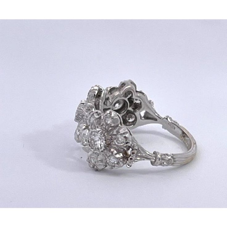 This is part of Chairish’s Fine Jewelry assortment.  Buccellati 18K White gold Diamond 3 Blossom Ring This Buccellati ring is unique and completely special.  I have searched and can only find this ring in sterling silver.  It is signed Buccellati it is completely full of Diamonds.  I find this to be a perfect wedding band but for others it is a nice band ring as I have won it and get many compliments. The ring is in perfect condition no scratches or dents, all the stones are intact.  If you are Luxury White Gold Flower Ring For Wedding, Luxury Wedding Flower Ring With Brilliant Cut Diamonds, Luxury Wedding Flower Ring With Brilliant Cut, Luxury Multi-stone Diamond Cluster Ring, Luxury Multi-stone Cluster Diamond Ring, Diamond White Flower Ring Fine Jewelry, Fine Jewelry Flower Ring With Prong Setting For Anniversary, Luxury Flower Ring With Center Stone For Wedding, Elegant White Gold Flower Ring With Rose Cut Diamonds