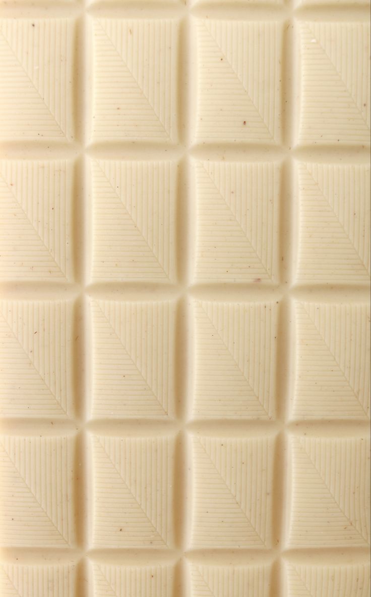 a close up view of the texture of a white chocolate bar, with diagonals