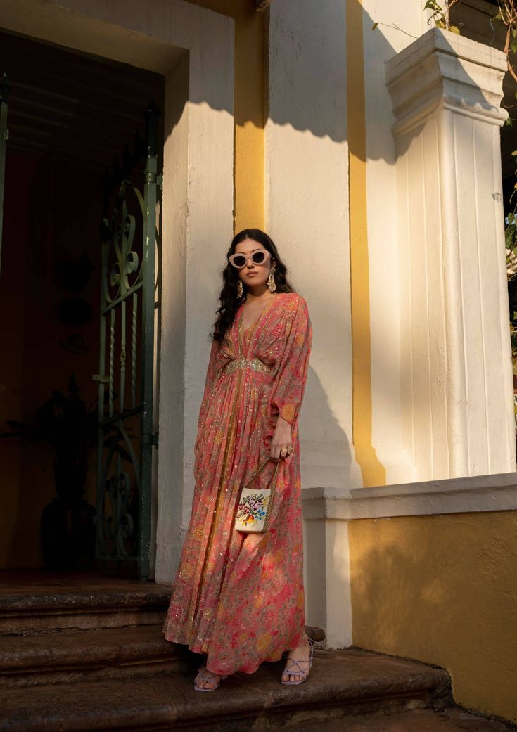 Our easy breezy festive wear kaftan expresses the classic romantic vibe, crafted using multiple prints which is digitally printed on pure georgette. The kaftan is accented with beautiful blooming floral and multi color stripes with dainty printed motifs. It is sprinkled using zari, floral sequins and mirror. It is has attached patch with is heavy embroidered. Festive Floral Print Dresses With Kimono Sleeves, Festive Floral Print Dress With Kimono Sleeves, Bohemian Georgette Kaftan With Floral Print, Floor-length Georgette Kaftan For Spring, Spring Maxi Length Georgette Kaftan, Festive Multicolor Floral Print Kaftan, Bohemian Georgette Beach Dress, Bohemian Georgette Kaftan For Spring, Spring Bohemian Georgette Kaftan