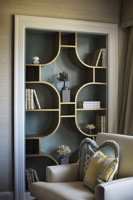 a white chair sitting in front of a book shelf