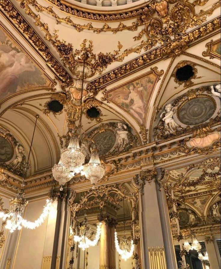 an ornately decorated room with chandeliers and paintings on the ceiling is shown